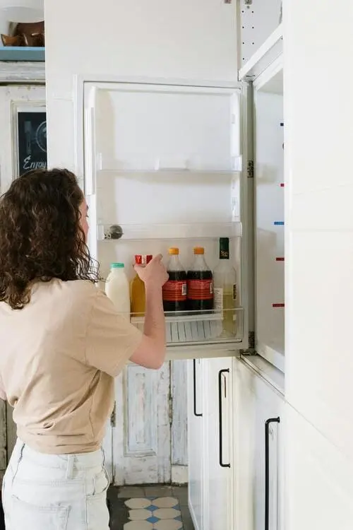Woman taking food from a refrigerator