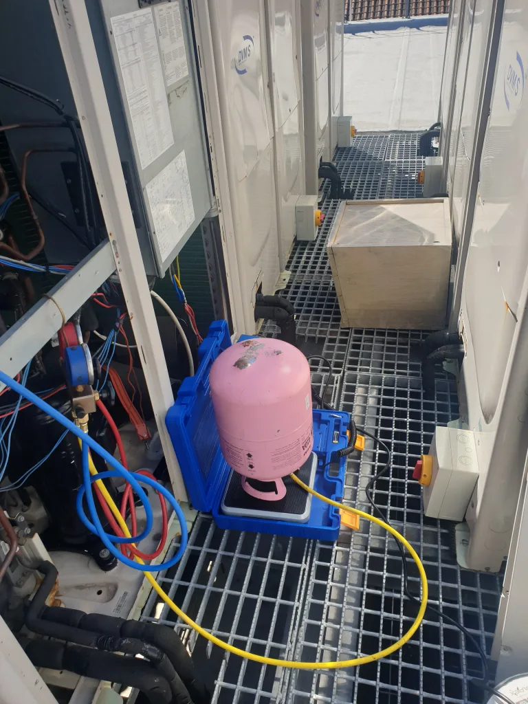 Refrigerant being charged into an air conditioning system